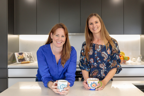 Suellen & Rachel drinking tea together in the kitchen