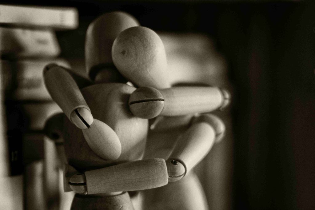 Two Wooden Figurines Embracing
